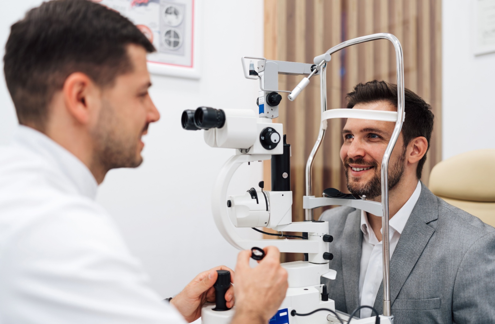 A patient talks to their optometrist during a comprehensive eye exam about laser eye surgery consultations