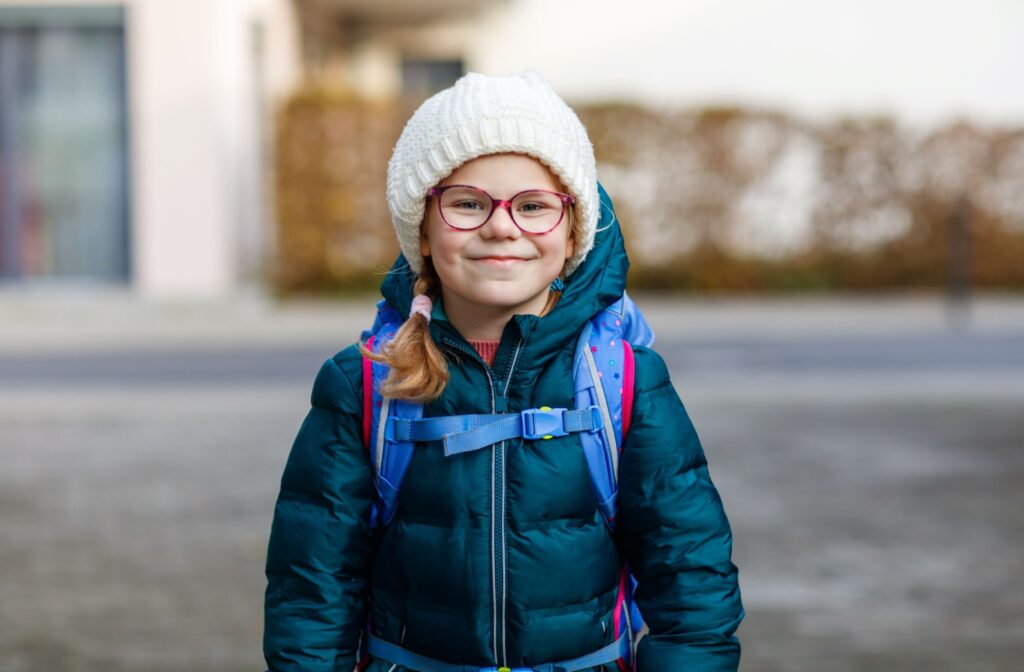 Child wearing glasses for nearsightedness correction emphasizing the importance of proper lenses for clear distance vision.